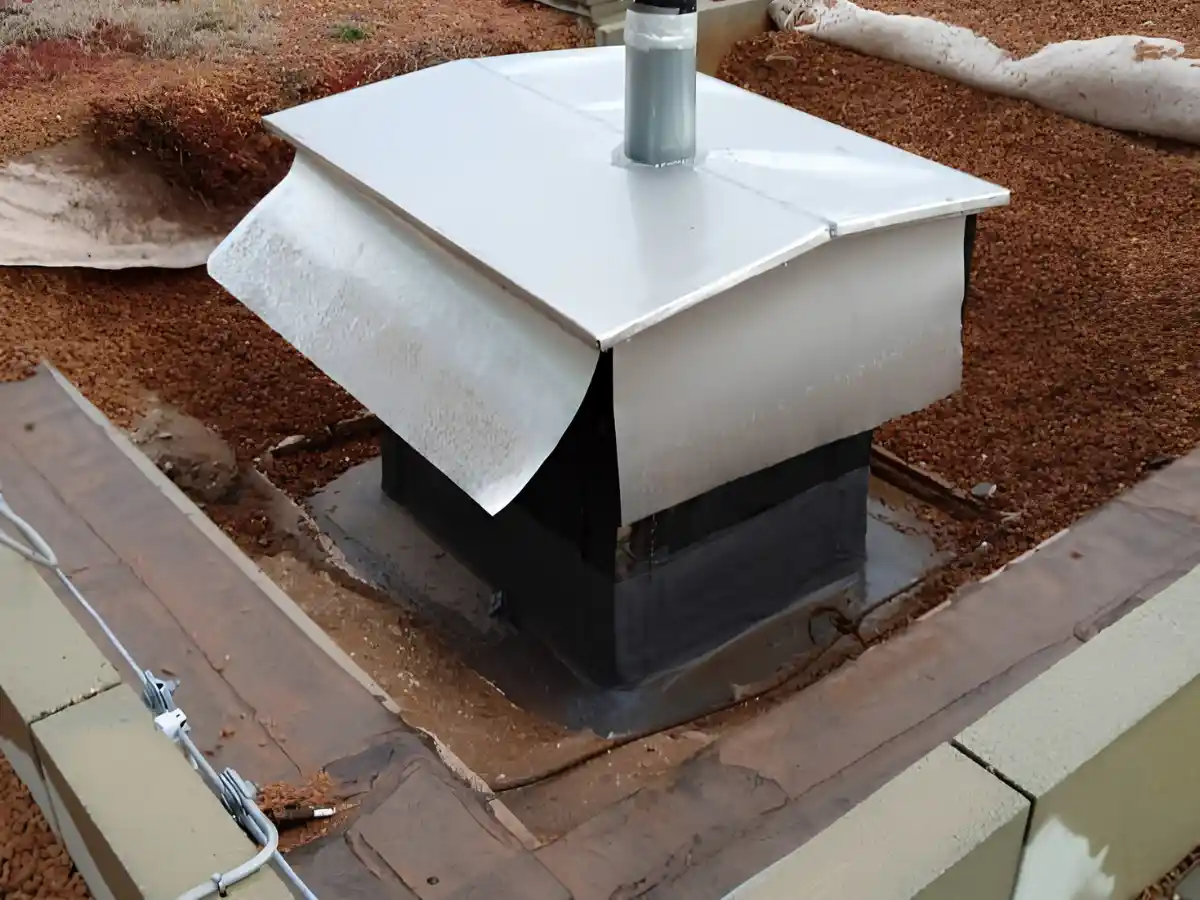 Screened cap on a brick chimney