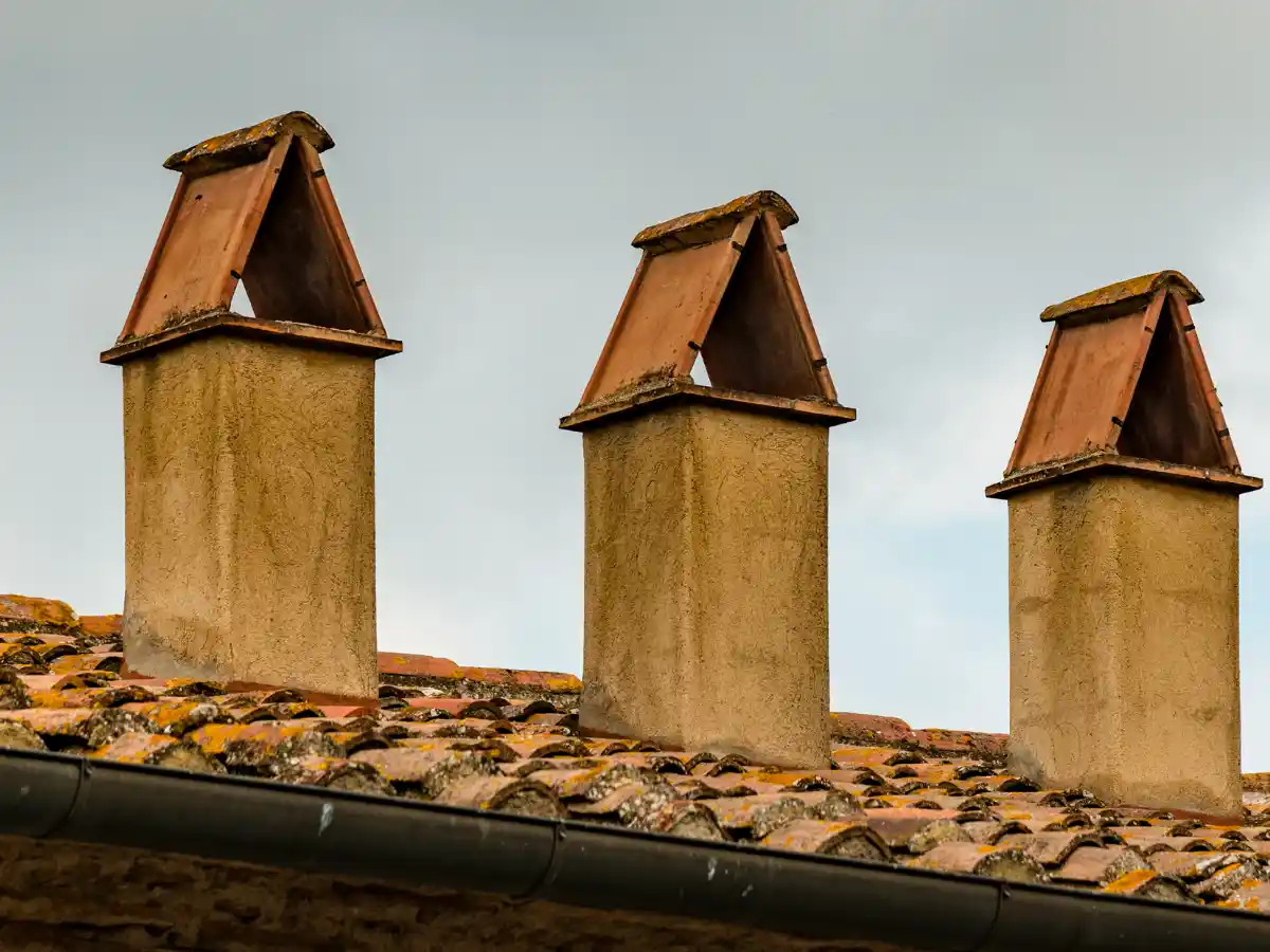 Stone chimney with a metal cap