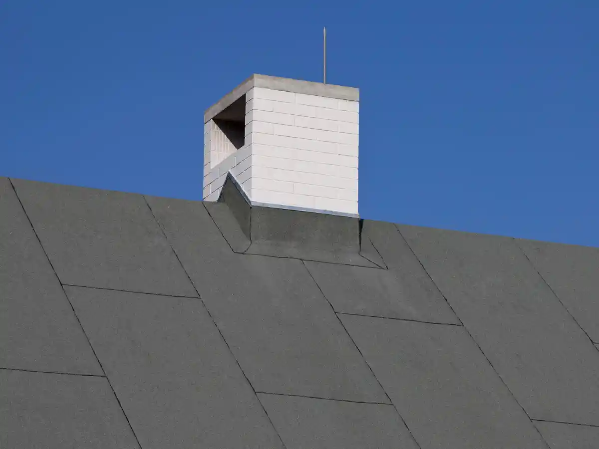 Brick chimney above a tile roof
