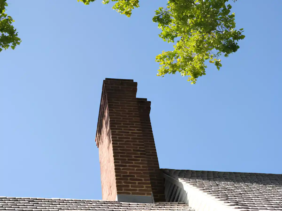 Stone chimney with a metal cap