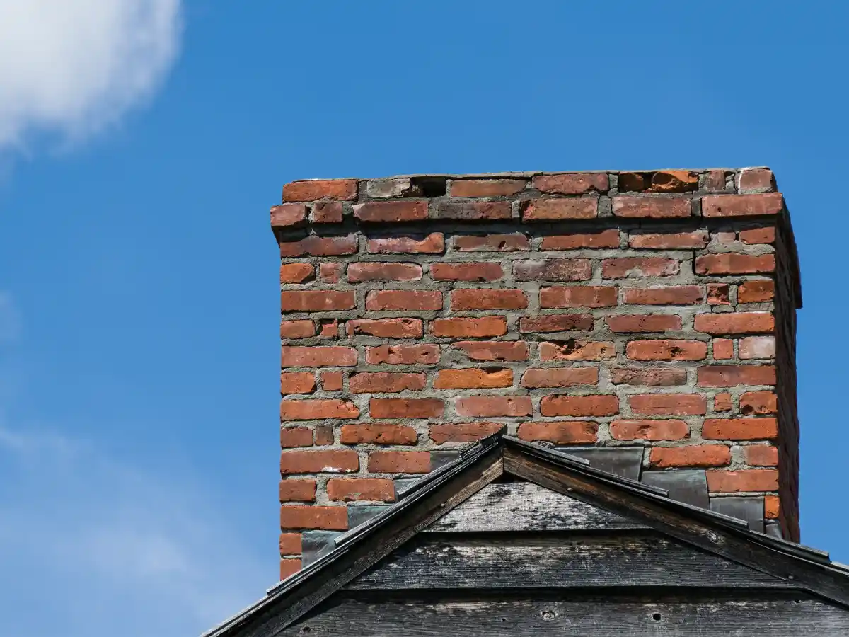 Stone chimney with a metal cap