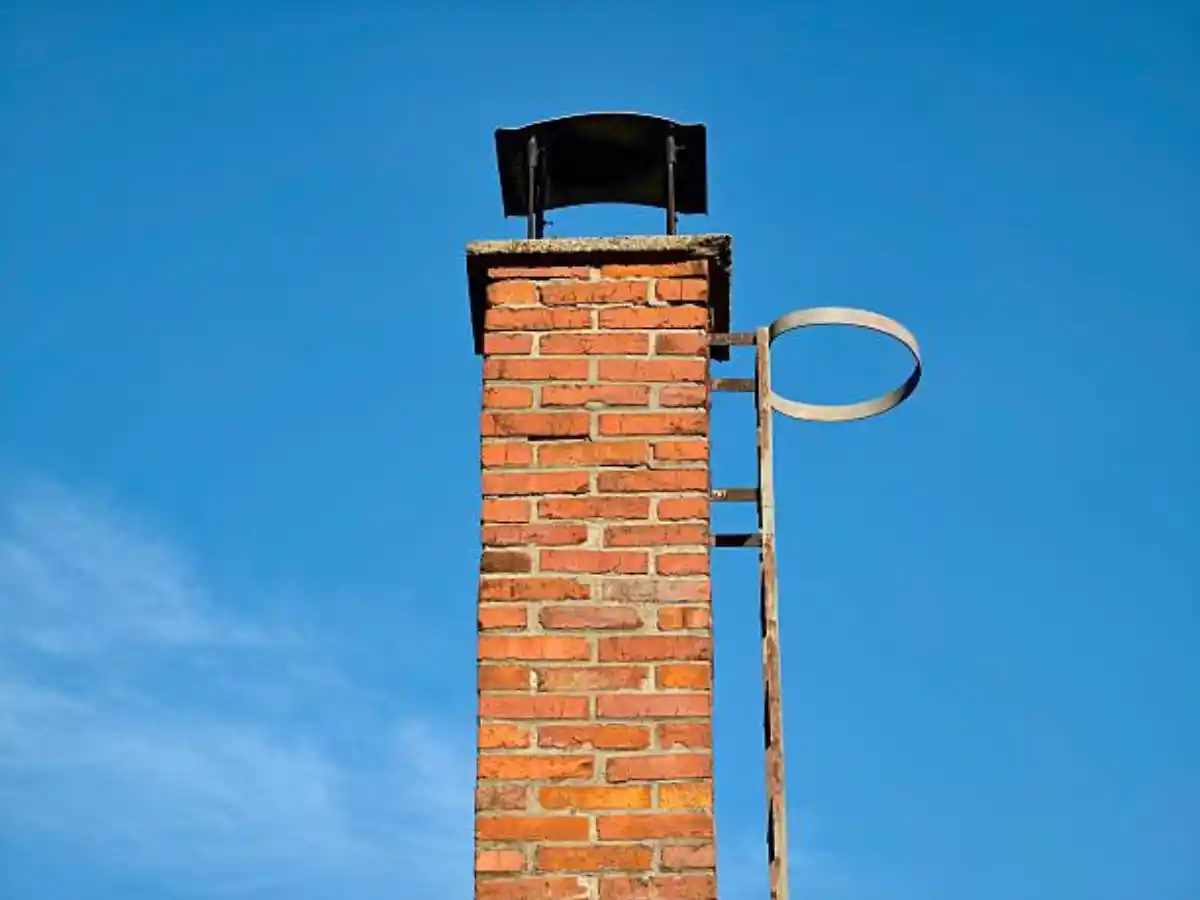 Brick chimney above a tile roof