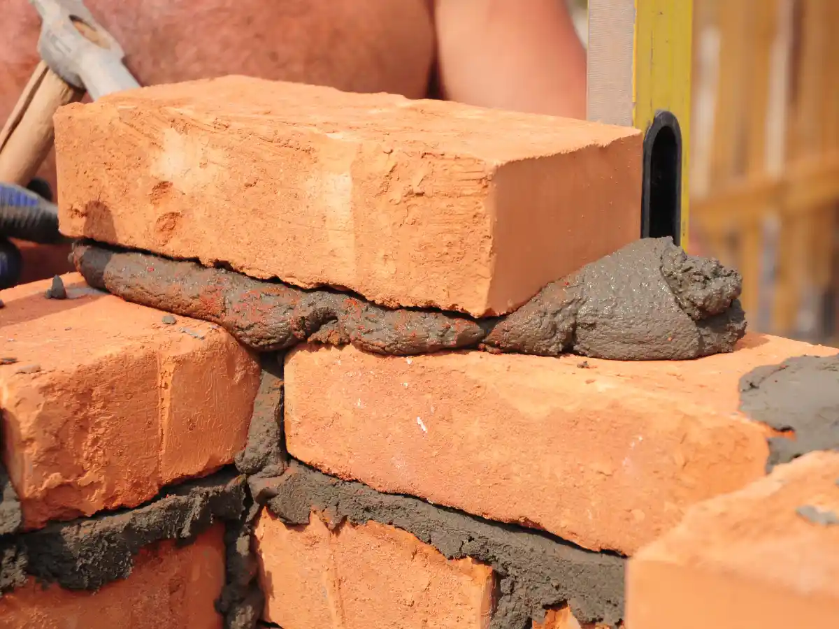 Mason repointing chimney brick